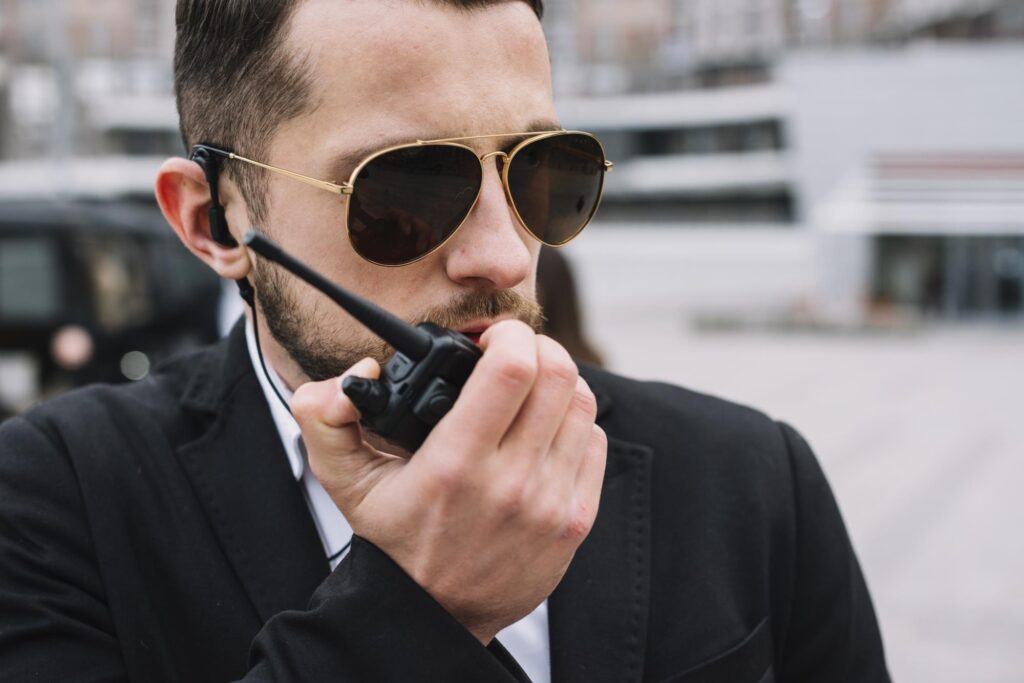 a body guard talking with walkie talkie